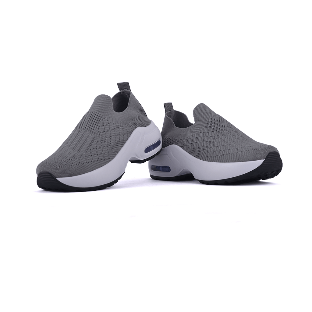 Zapatillas FlexG grises con diseño moderno y suela flexible, ideales para confort y estilo en cada paso.